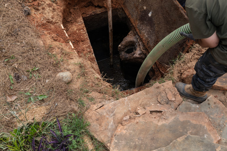 Pumping sludge from an opened septic tank